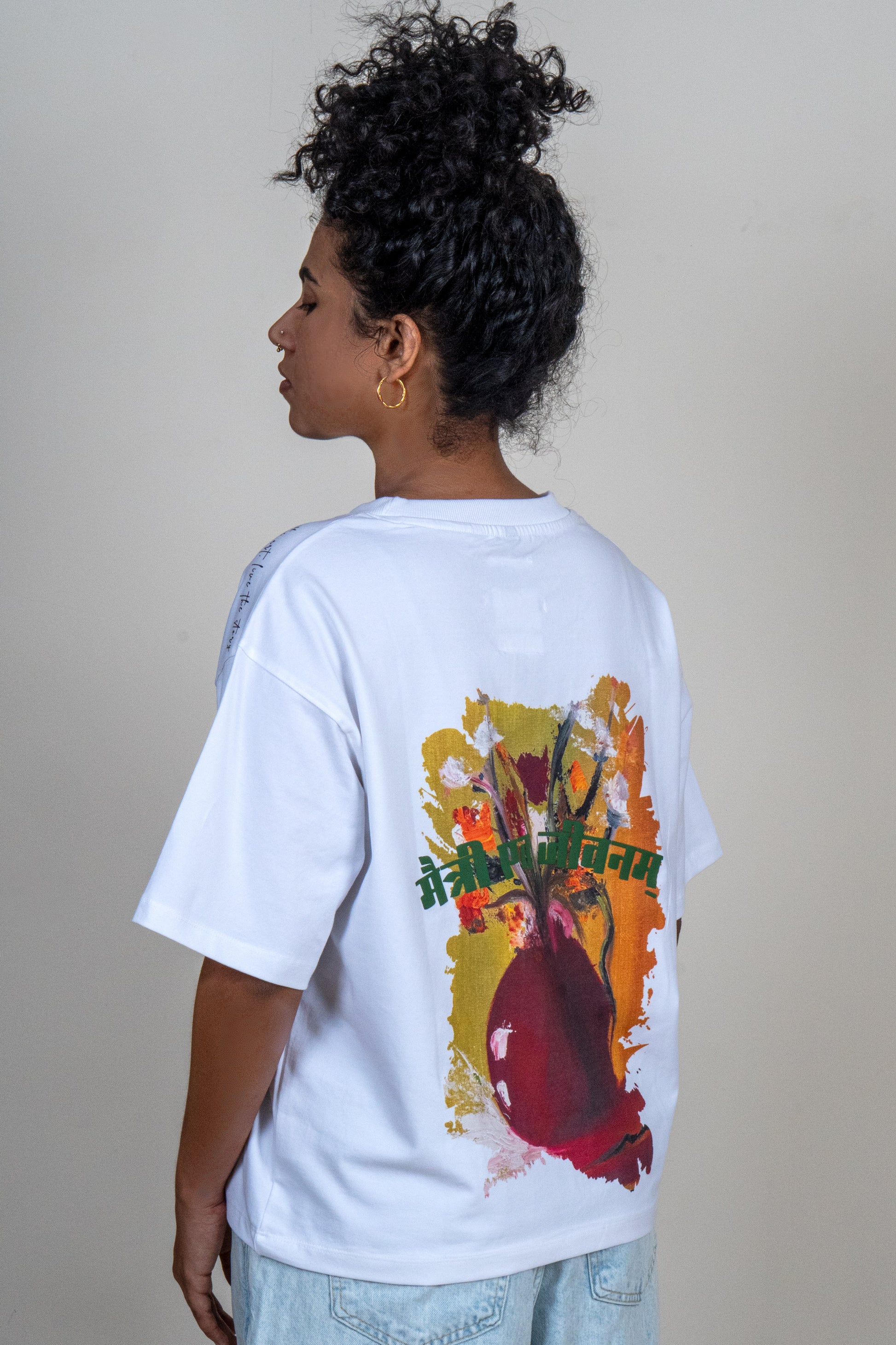 DOKAI Oversized T-shirt on model — back view showing Memento Mori art print by Priyanka Chandra, limited edition wearable art by GEEMEEO